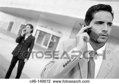 Executives talking on cellular phone View Large Photo Image Stock Image - Executives talking on cellular phone. Fotosearch