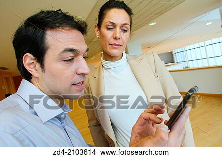 Picture - Executives using smartphone. Fotosearch