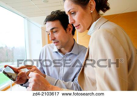 Executives using smartphone View Large Photo Image Stock Photo - Executives using smartphone. Fotosearch