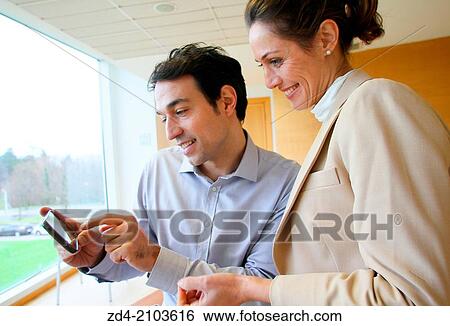 Stock Photograph - Executives using smartphone. Fotosearch