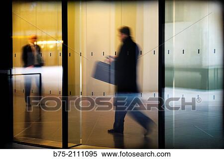 Executives walking down the hall of an office, City of London, England, UK, Europe. View Large Photo Image Stock Photography - Executives walking down the hall of an office, City of London, England, UK, Europe.. Fotosearch