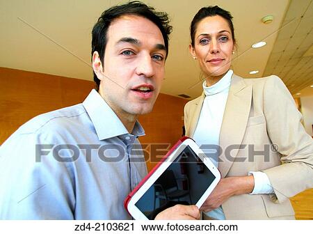 Stock Image - Executives with digital tablet. Fotosearch