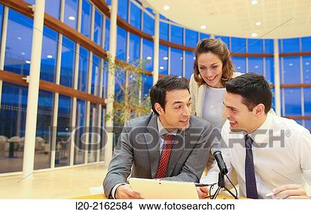 Picture - Executives with digital tablet, video conference. Fotosearch
