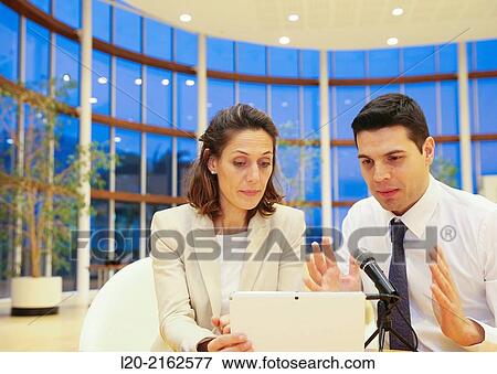 Executives with digital tablet, video conference View Large Photo Image Stock Photo - Executives with digital tablet, video conference. Fotosearch