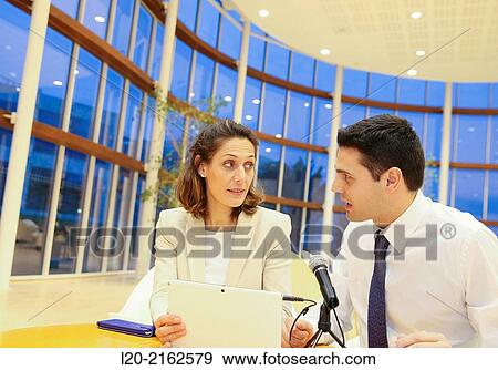 Stock Photo - Executives with digital tablet, video conference. Fotosearch