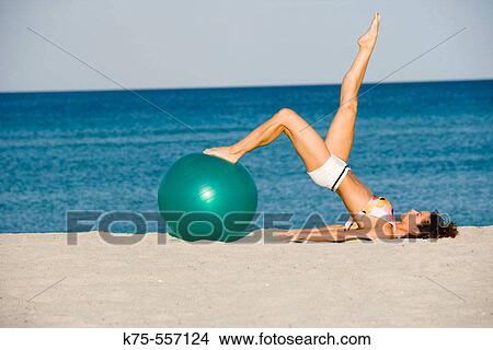 Exercise ball, beach, caucasian/hispanic, age 30 to 40. View Large Photo Image Picture - Exercise ball, beach, caucasian/hispanic, age 30 to 40.. Fotosearch