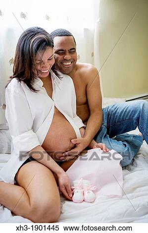 Expecting couple embracing View Large Photo Image Stock Photography - Expecting couple embracing. Fotosearch