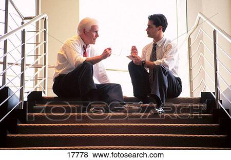 Experienced business man gives advice to young man View Large Photo Image Stock Photo - Experienced business man gives advice to young man. Fotosearch