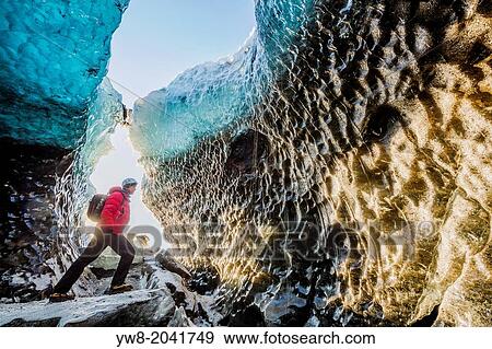 Stock Photo - Exploring a glacial ice cave, Svinafellsjokull, Iceland.. Fotosearch