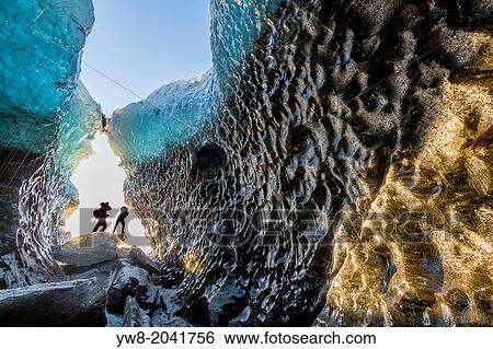 Stock Photograph - Exploring a glacial ice cave, Svinafellsjokull, Iceland.. Fotosearch