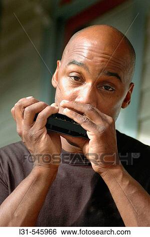 Expressive man playing his harmonica for entertainment Mouthharp Harp View Large Photo Image Stock Photograph - Expressive man playing his harmonica for entertainment Mouthharp Harp. Fotosearch