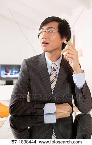 Expressive young Asian businessman View Large Photo Image Picture - Expressive young Asian businessman. Fotosearch