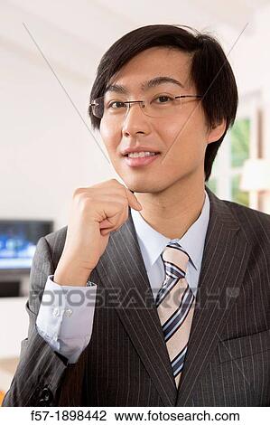 Stock Image - Expressive young Asian businessman. Fotosearch