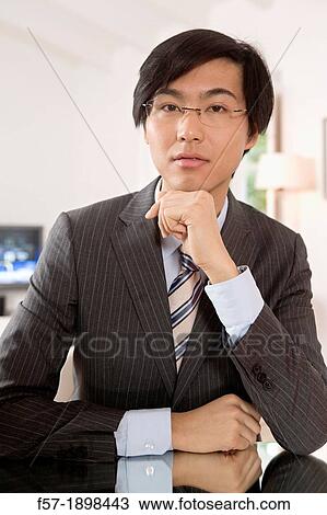 Stock Image - Expressive young Asian businessman. Fotosearch