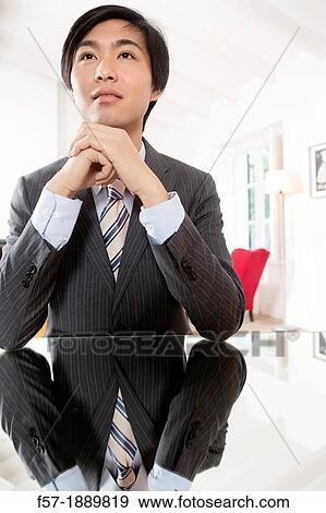 Expressive young Asian businessman View Large Photo Image Stock Photo - Expressive young Asian businessman. Fotosearch