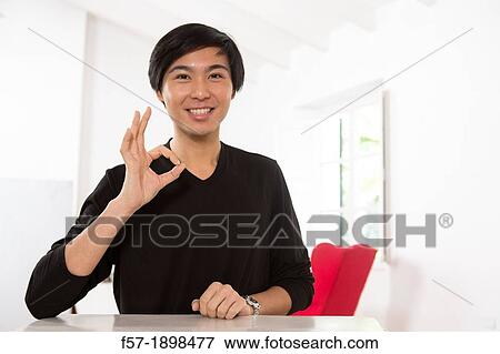Stock Photo - Expressive young Asian man. Fotosearch