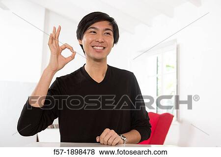 Expressive young Asian man View Large Photo Image Stock Photo - Expressive young Asian man. Fotosearch
