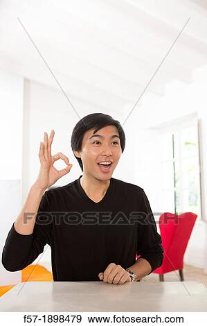 Stock Photo - Expressive young Asian man. Fotosearch