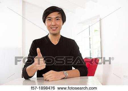 Expressive young Asian man View Large Photo Image Stock Photograph - Expressive young Asian man. Fotosearch