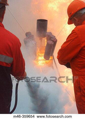 Extinguishing a training fire. View Large Photo Image Picture - Extinguishing a training fire.. Fotosearch