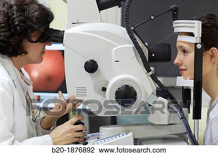 Eye examination Doctor using a retinal camera during an angiography examination of a patient's eye View Large Photo Image Stock Image - Eye examination Doctor using a retinal camera during an angiography examination of a patient's eye. Fotosearch