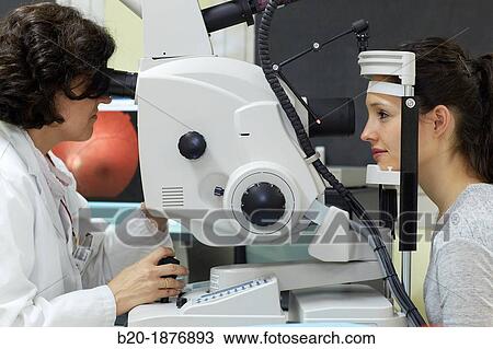 Eye examination Doctor using a retinal camera during an angiography examination of a patient's eye View Large Photo Image Stock Image - Eye examination Doctor using a retinal camera during an angiography examination of a patient's eye. Fotosearch