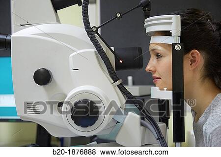 Eye examination Doctor using a retinal camera during an angiography examination of a patient's eye View Large Photo Image Stock Photo - Eye examination Doctor using a retinal camera during an angiography examination of a patient's eye. Fotosearch