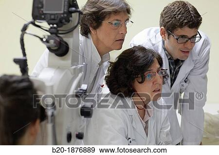 Eye examination Doctor using a retinal camera during an angiography examination of a patient's eye View Large Photo Image Stock Photo - Eye examination Doctor using a retinal camera during an angiography examination of a patient's eye. Fotosearch
