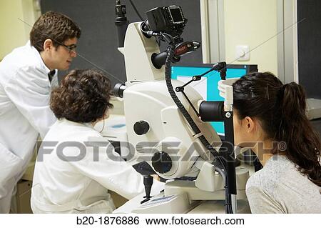 Eye examination Doctor using a retinal camera during an angiography examination of a patient's eye View Large Photo Image Stock Photograph - Eye examination Doctor using a retinal camera during an angiography examination of a patient's eye. Fotosearch
