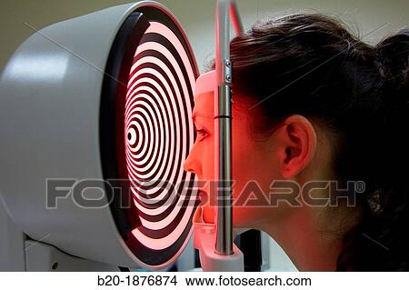 Eye examination Patient having a corneal topography measurement made of her eye View Large Photo Image Picture - Eye examination Patient having a corneal topography measurement made of her eye. Fotosearch