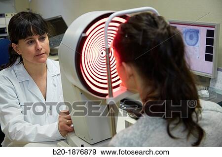 Eye examination Patient having a corneal topography measurement made of her eye View Large Photo Image Stock Photo - Eye examination Patient having a corneal topography measurement made of her eye. Fotosearch
