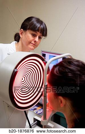 Eye examination Patient having a corneal topography measurement made of her eye View Large Photo Image Stock Photograph - Eye examination Patient having a corneal topography measurement made of her eye. Fotosearch