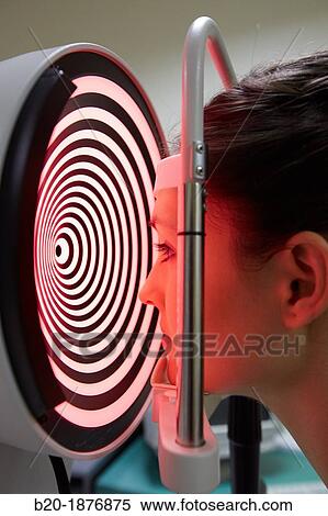 Stock Photography - Eye examination Patient having a corneal topography measurement made of her eye. Fotosearch