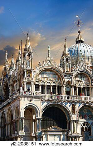Stock Image - Facade with Gothic architecture and Romanesque domes of St Mark's Basilica, Venice.. Fotosearch