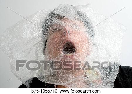 Stock Image - Face of woman with symptoms of panic with plastic on the face. Fotosearch