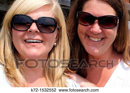 Faces of laughing female friends View Large Photo Image Stock Image - Faces of laughing female friends. Fotosearch
