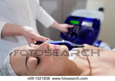 Stock Photo - Facial treatment in a beauty center. Fotosearch
