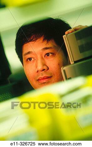 Factory worker with components for cellular industry View Large Photo Image Stock Photography - Factory worker with components for cellular industry. Fotosearch
