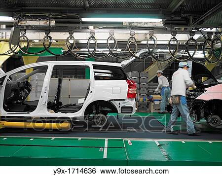 Factory workers producing Toyota cars and vans, work on the assembly line at the Toyota City factory in Japan. This is also where the Toyota Prius is assembled. View Large Photo Image Stock Photograph - Factory workers producing Toyota cars and vans, work on the assembly line at the Toyota City factory in Japan. This is also where the Toyota Prius is assembled.. Fotosearch
