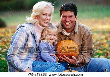 Stock Image - family and a jack o? lantern. Fotosearch