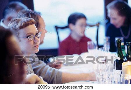 Stock Photography - Family at dinner table. Fotosearch