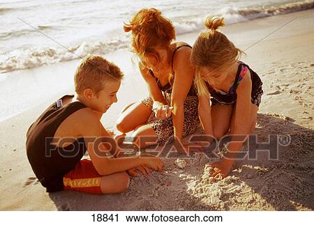 Stock Image - Family at the beach. Fotosearch
