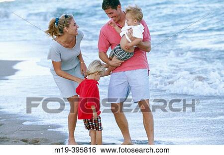 Stock Photograph - family at the beach. Fotosearch