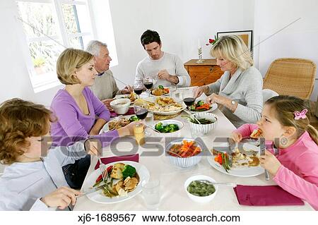 Family at the dinner table View Large Photo Image Stock Photo - Family at the dinner table. Fotosearch