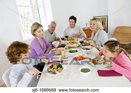 Family at the dinner table View Large Photo Image Stock Photo - Family at the dinner table. Fotosearch