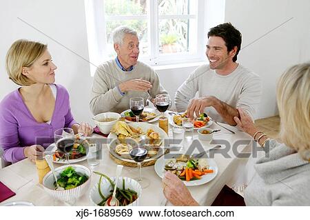 Family at the dinner table View Large Photo Image Stock Photo - Family at the dinner table. Fotosearch