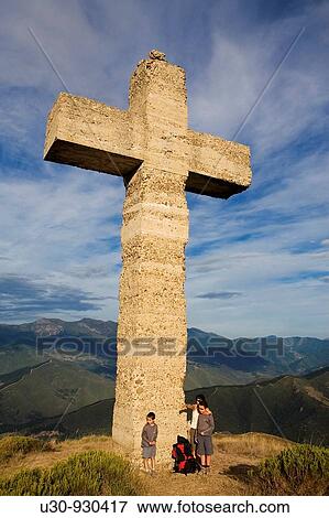 Stock Photo - Family beside Cruz de la Viorna in the Liebana Valley, next to the Picos de Europa National Park, in Cantabria, Spain. Fotosearch