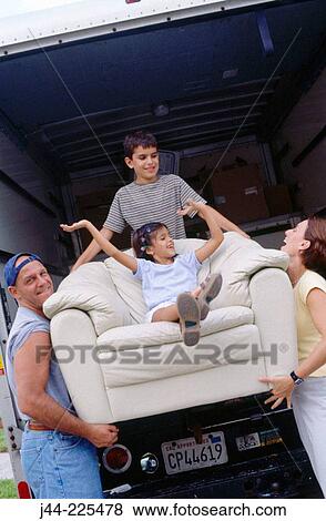 Family carrying chair with girl sitting on it View Large Photo Image Stock Photo - Family carrying chair with girl sitting on it. Fotosearch
