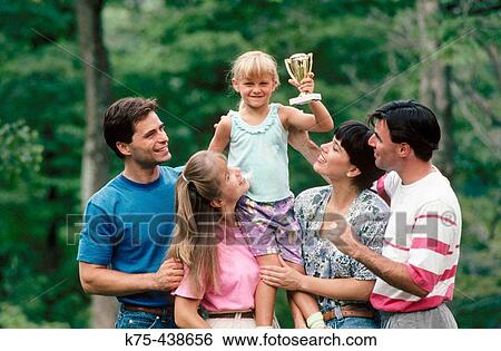 Stock Photograph - Family congratulating little girl. Fotosearch