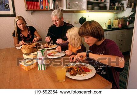Family diner at home (children 5 and 14). Stockholm. Sweden. View Large Photo Image Picture - Family diner at home (children 5 and 14). Stockholm. Sweden.. Fotosearch